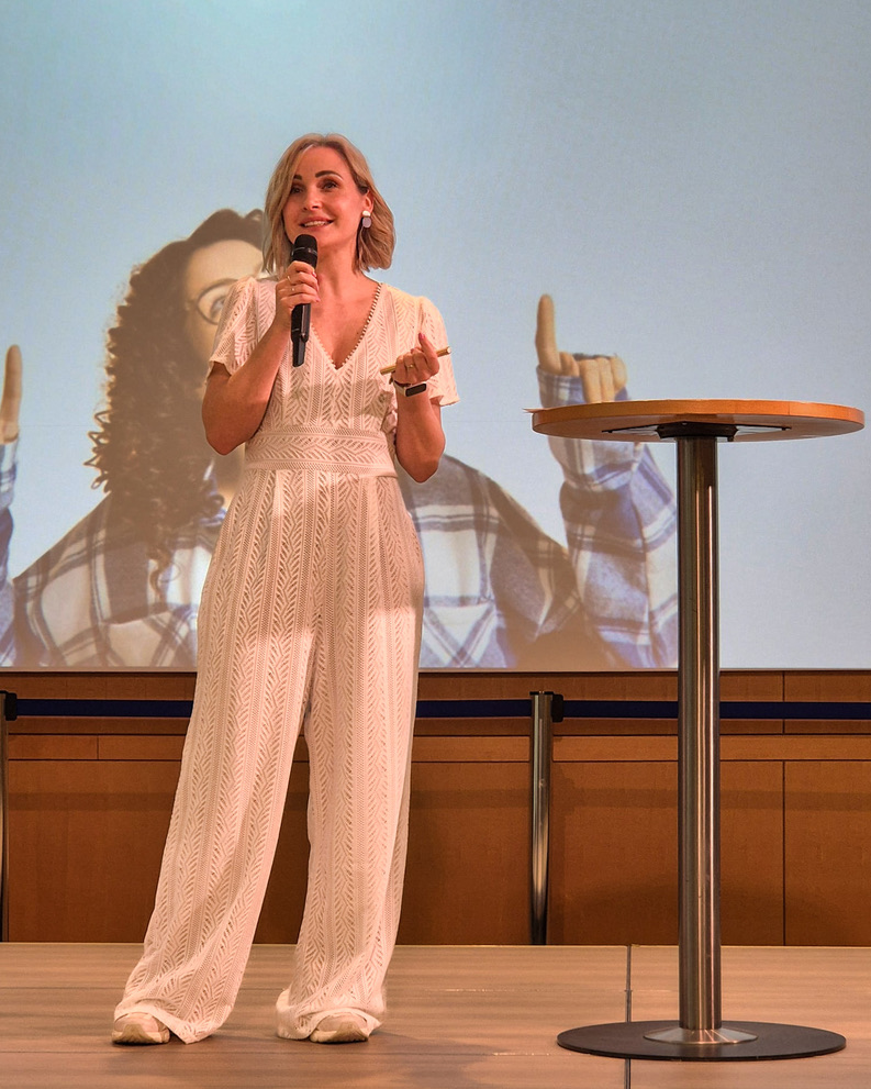 Sandra speaking on stage